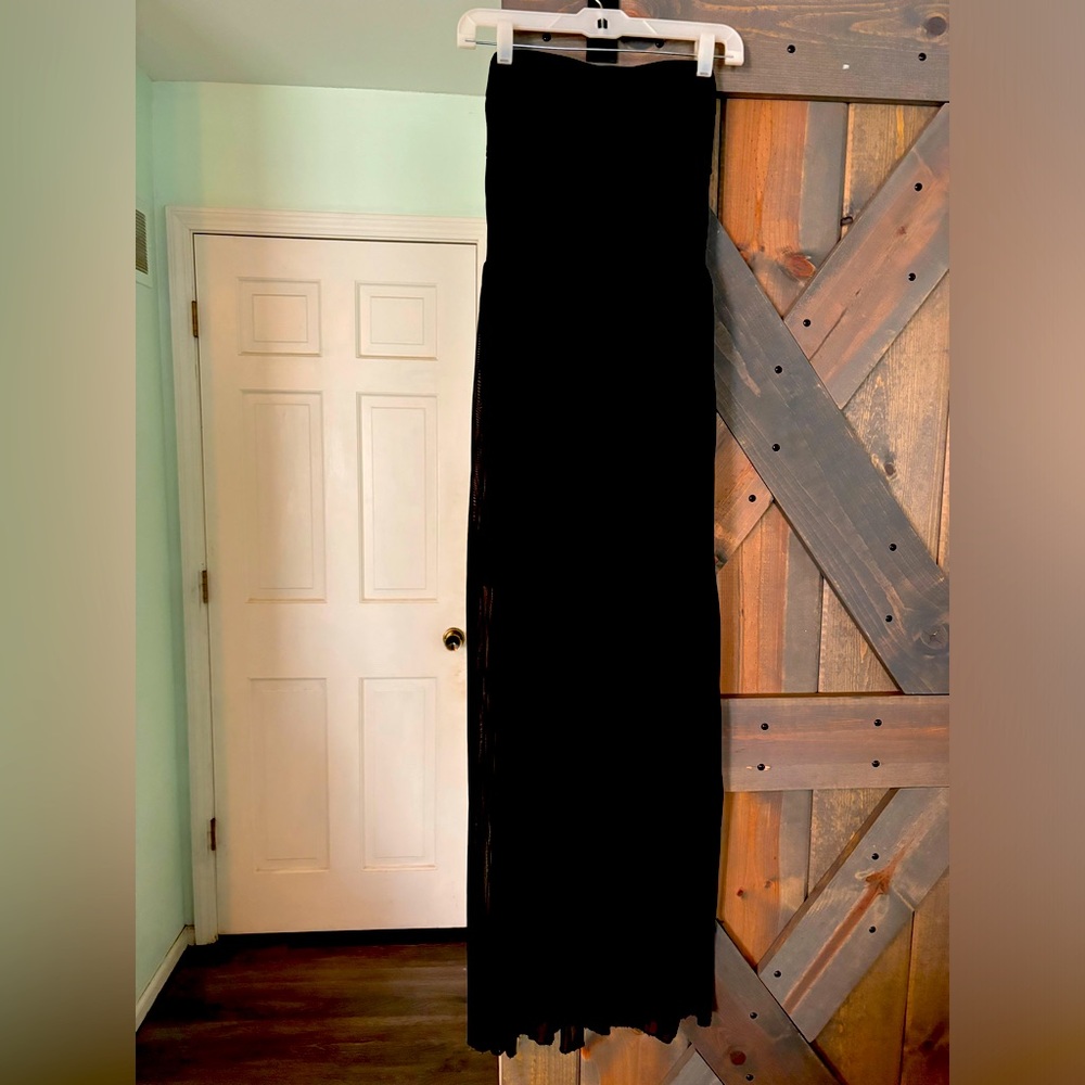 Black straplesss dress with sheer covering on the skirt.